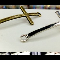 Sideways cross charm connector.